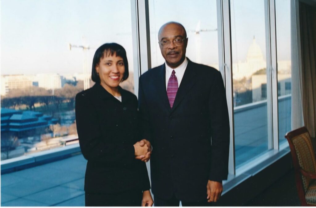 Dr. Paige with a woman, posed by a window.