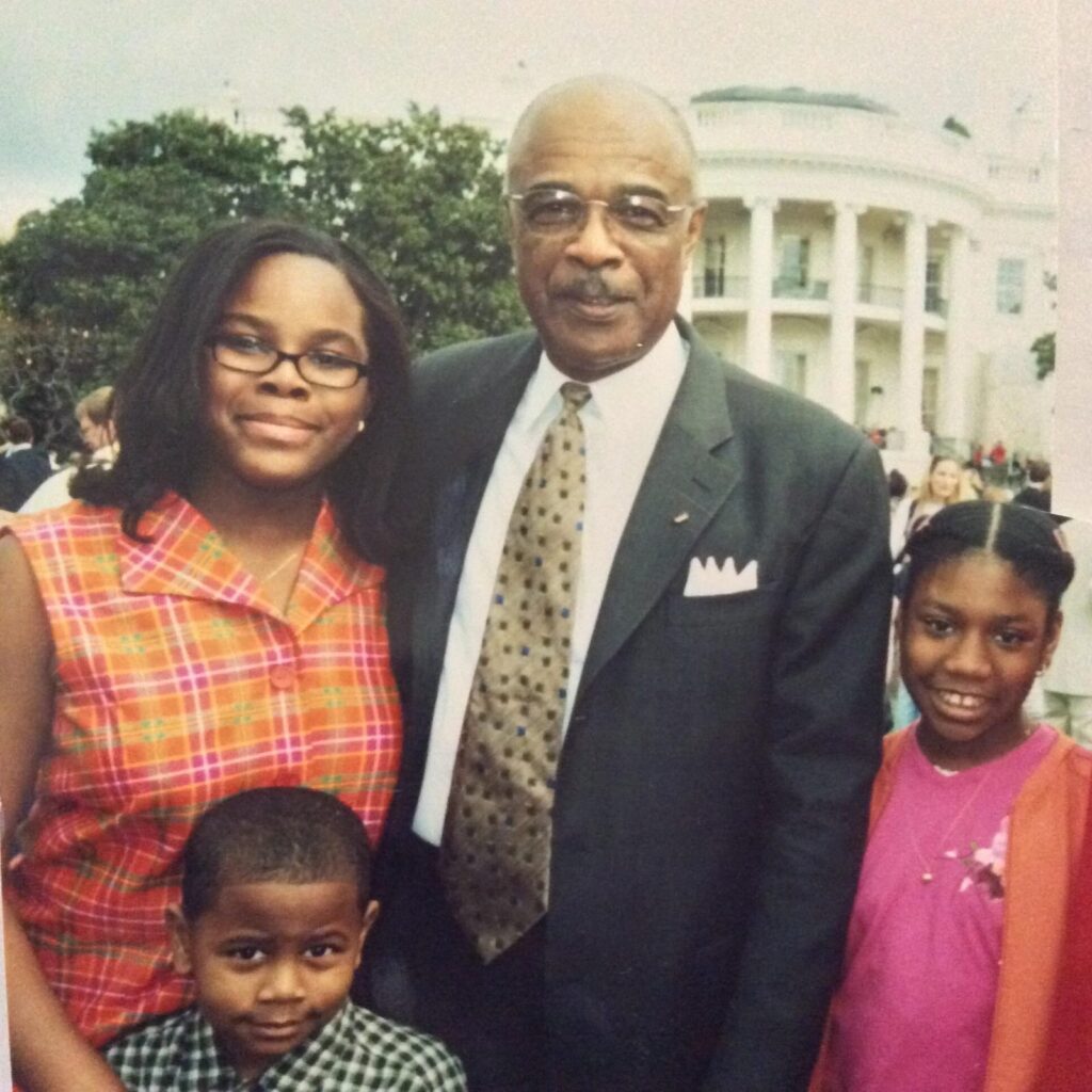 Dr. Paige with a woman and two girls.