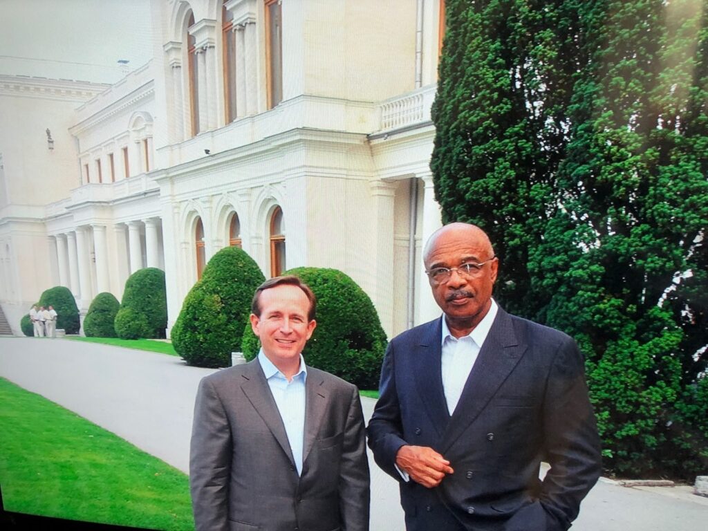 Dr. Paige with a man near a government building.