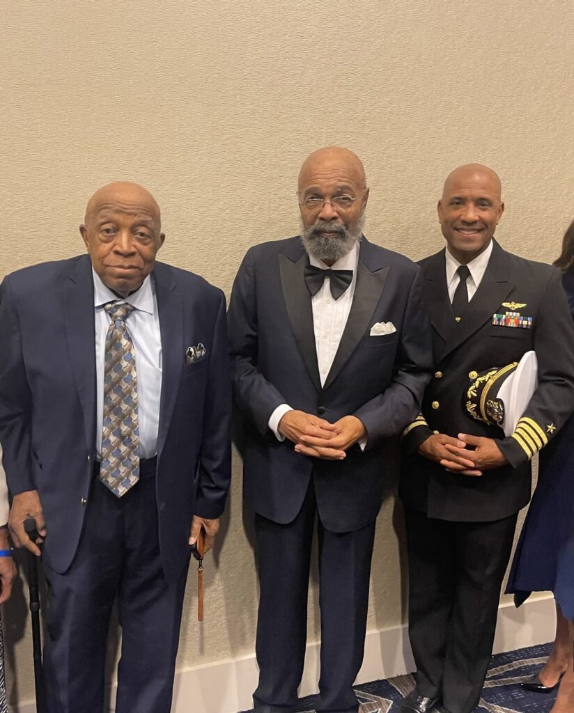 Dr. Paige receiving an award with two others.