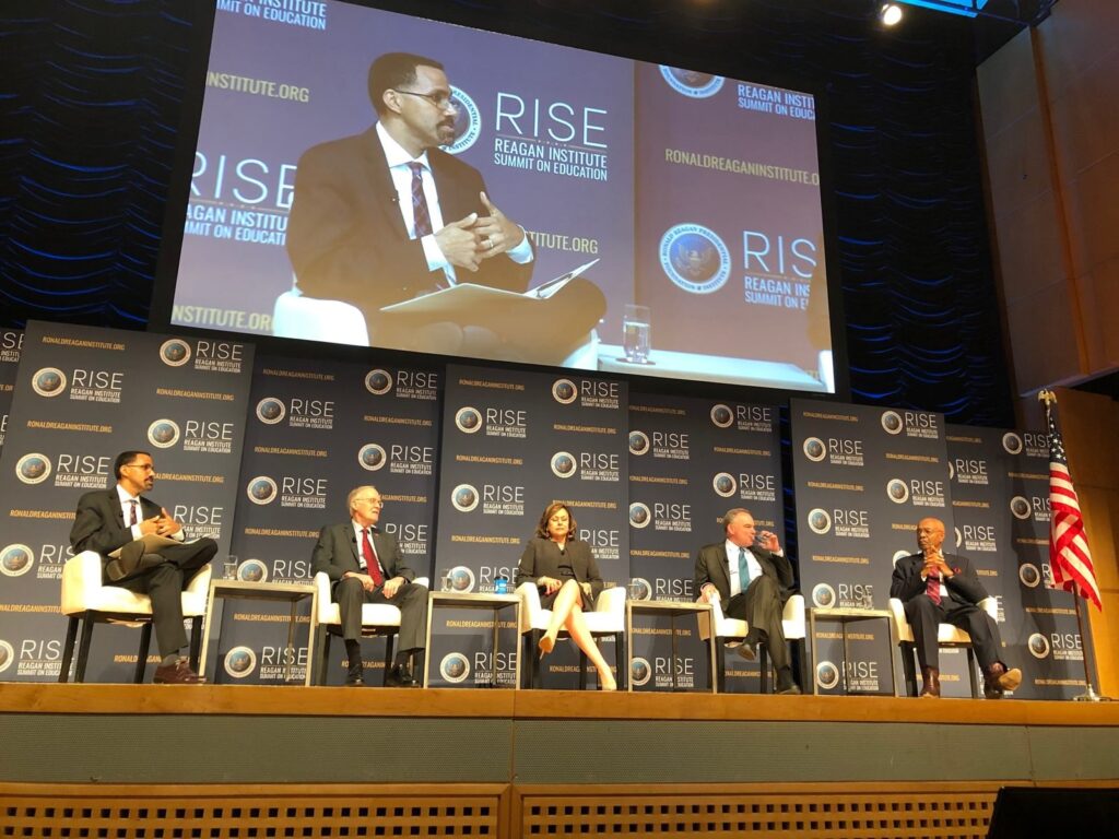 A conference panel on stage.