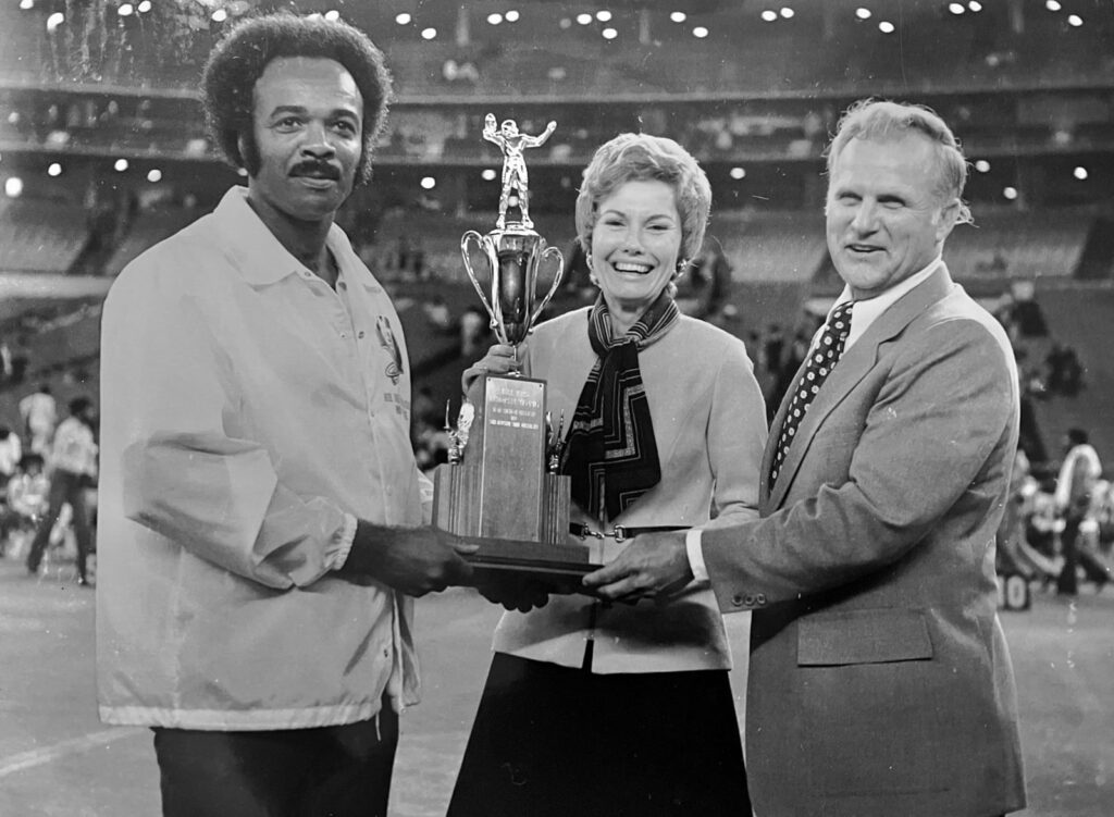 A trophy presentation; Dr. Paige with others.