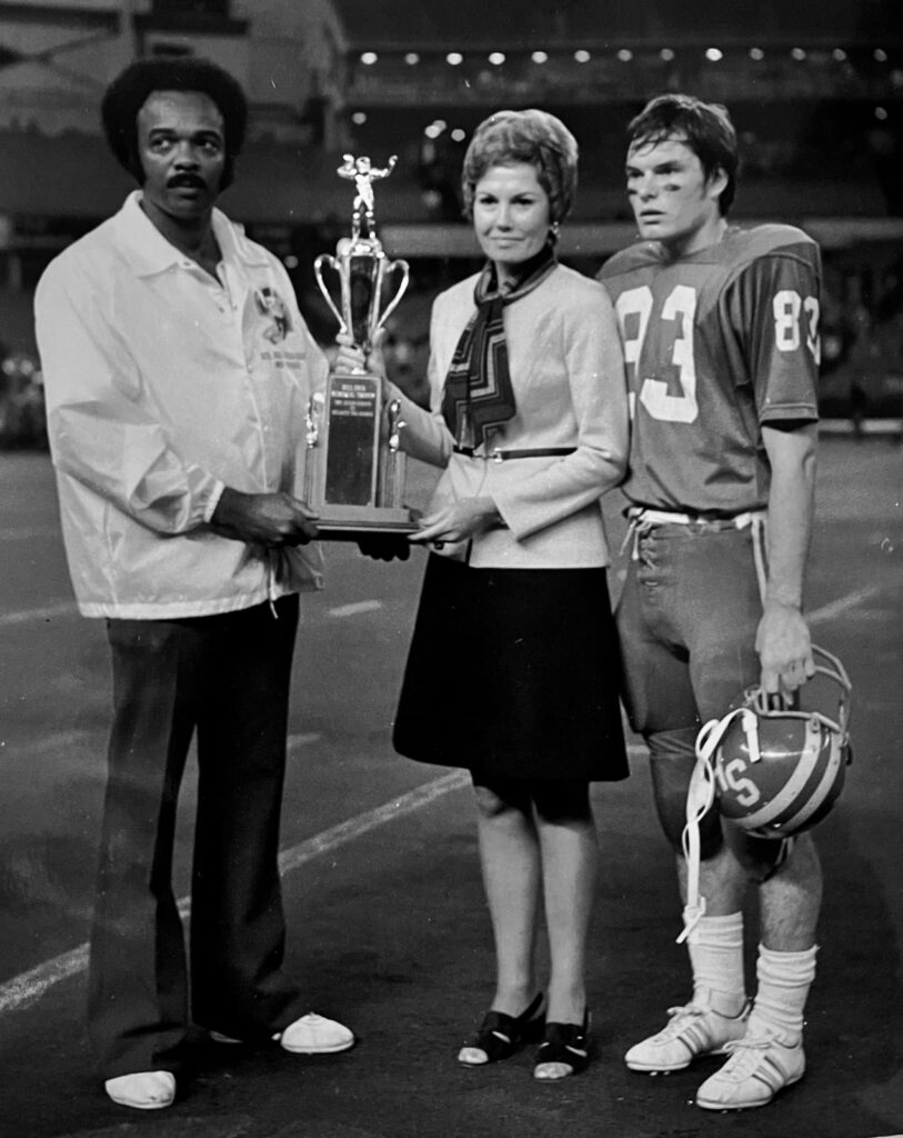 An award presentation on a football field.