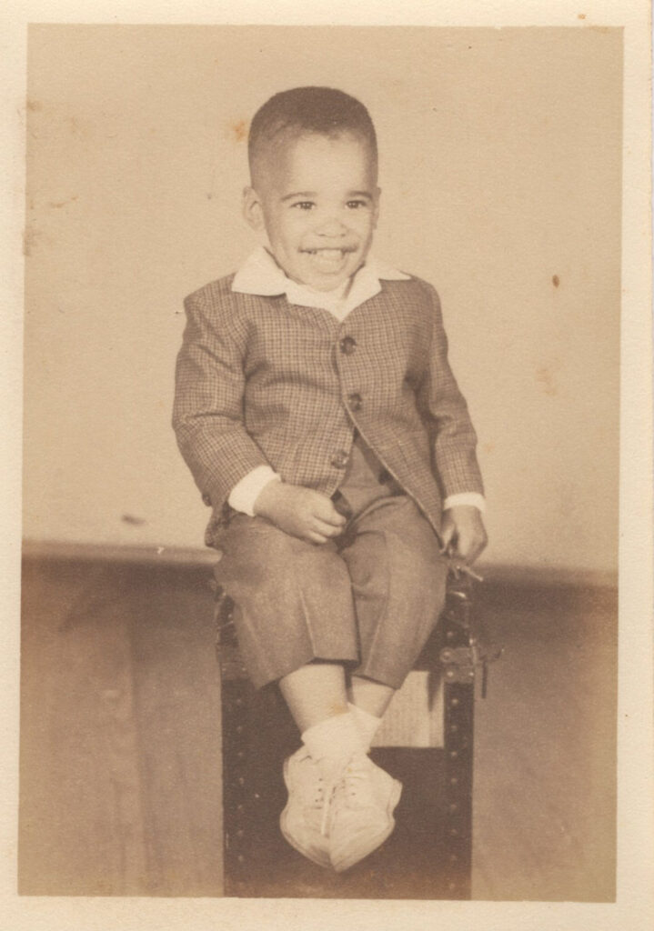 Vintage sepia photo of a young child standing.